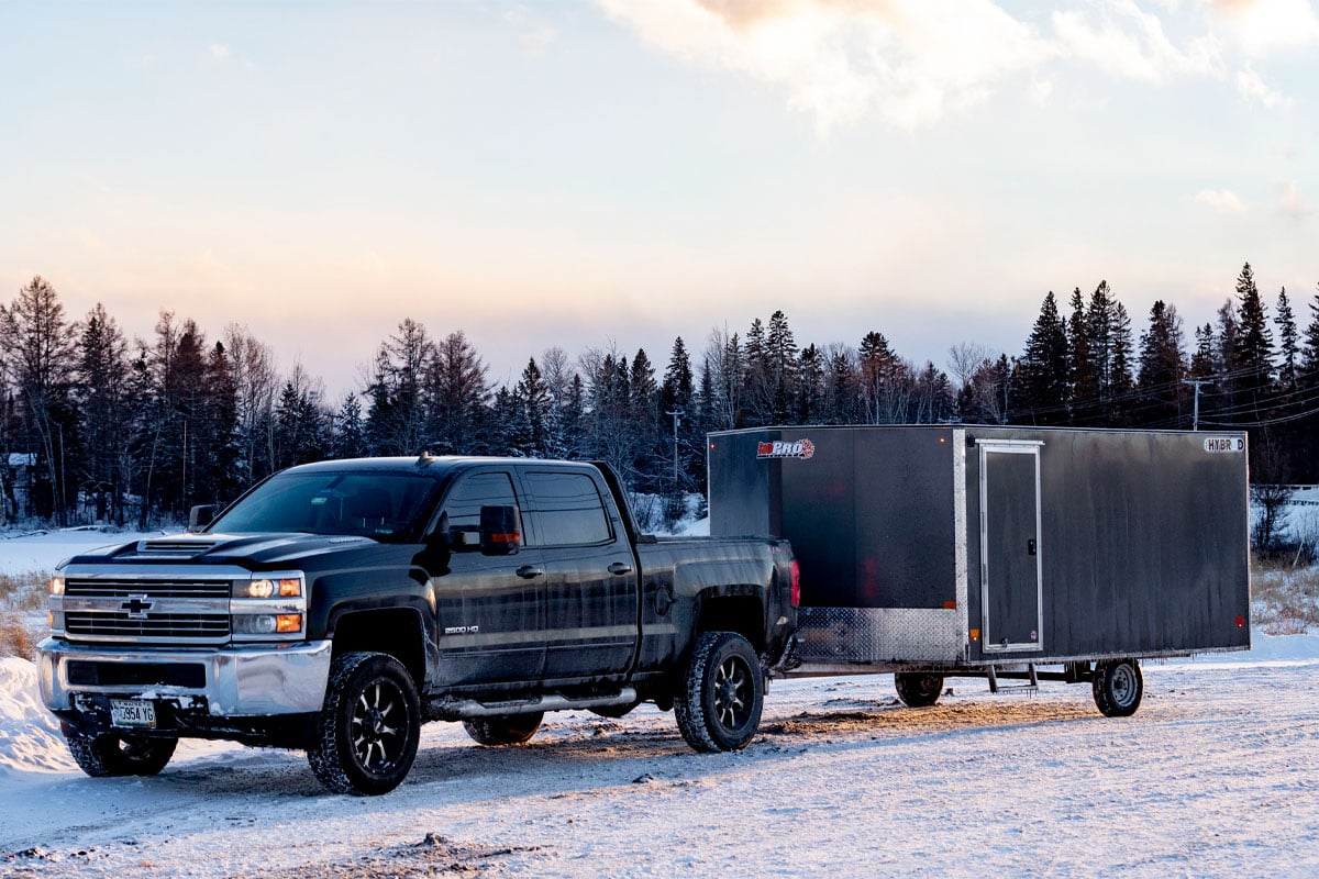 Black Truck Pulling Gray 2.0 Hybrid SnoPro Trailer Out In The Open