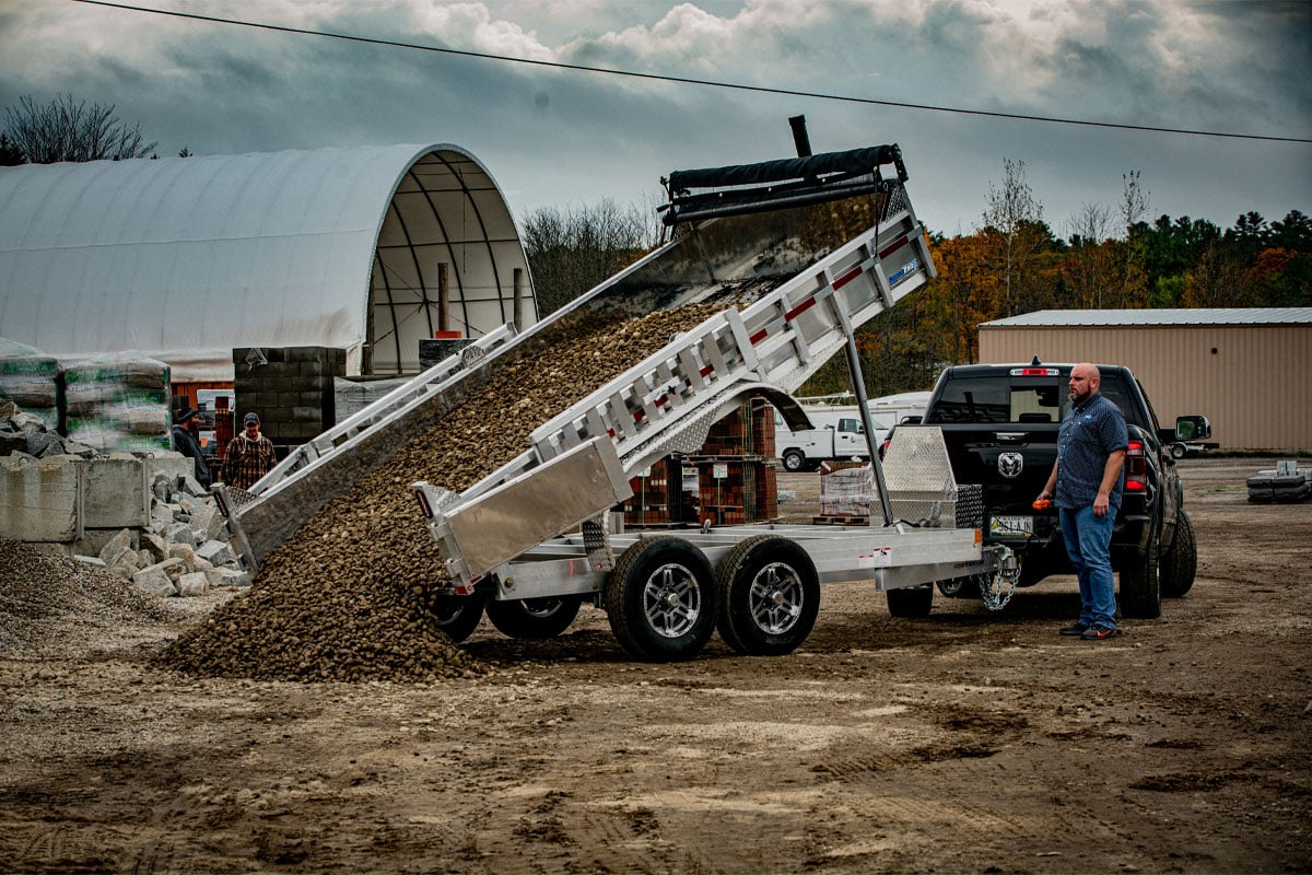 Commercial Utility Dump Trailer Dumping Stone At Landscape Site